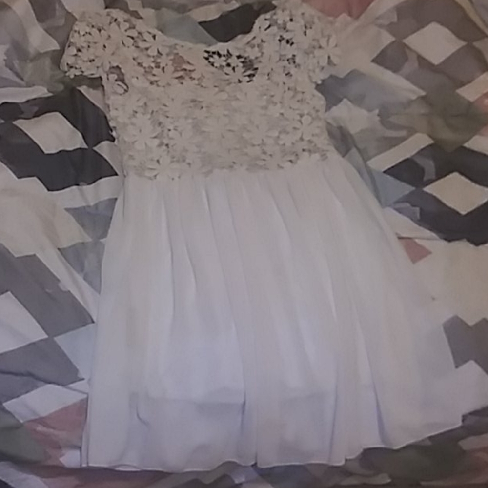 A white dress with a flower print on